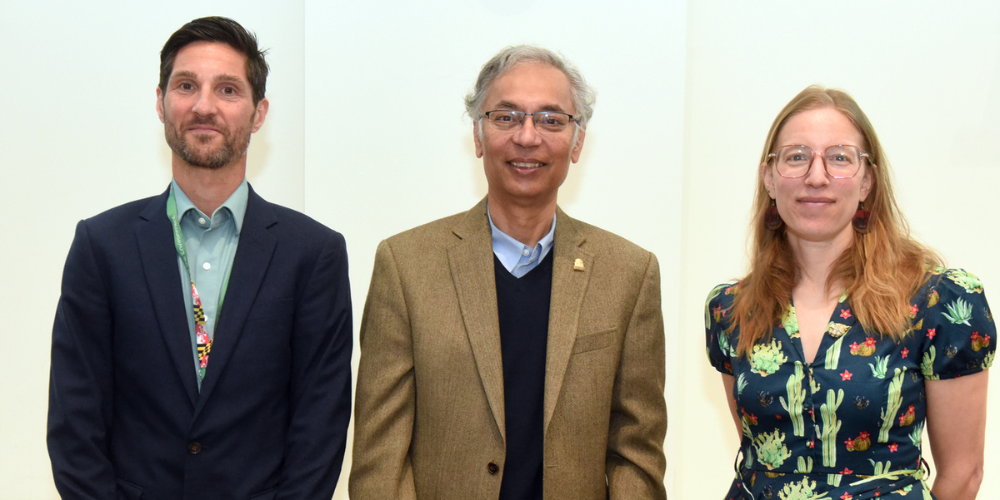Three people pose for a photo