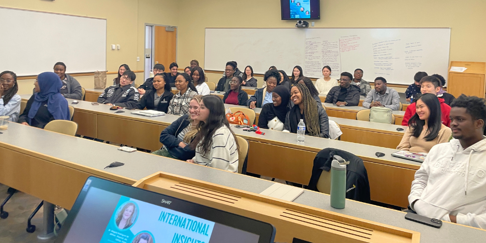 Students listen to speakers in a pharmacy classroom