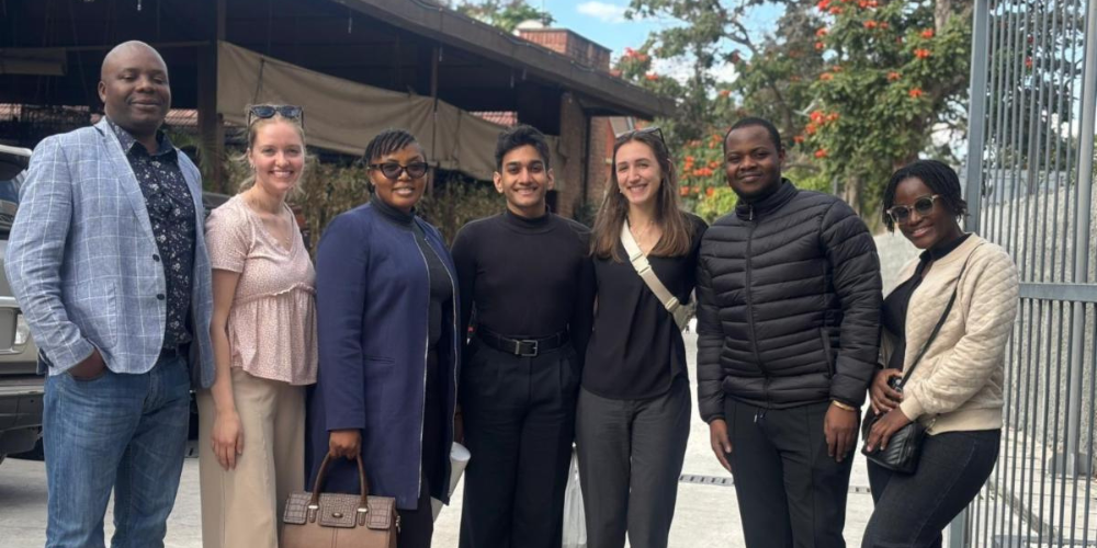 People pose for a group photo outside
