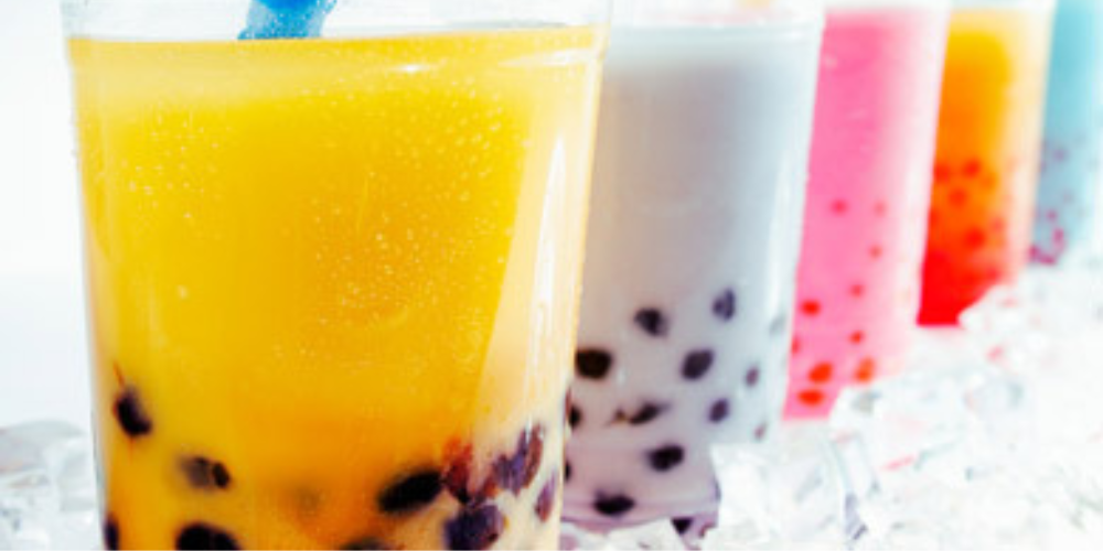 Cups filled with brightly colored bubble tea
