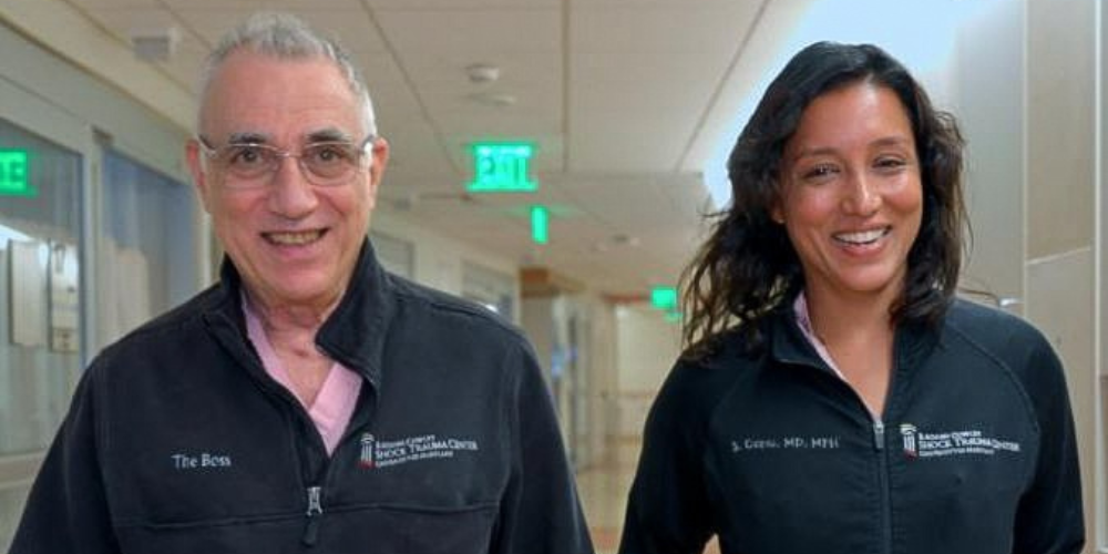 Dr. Thomas Scalea and Dr. Shailvi Gupta walk in the hallway of UMMC Shock Trauma