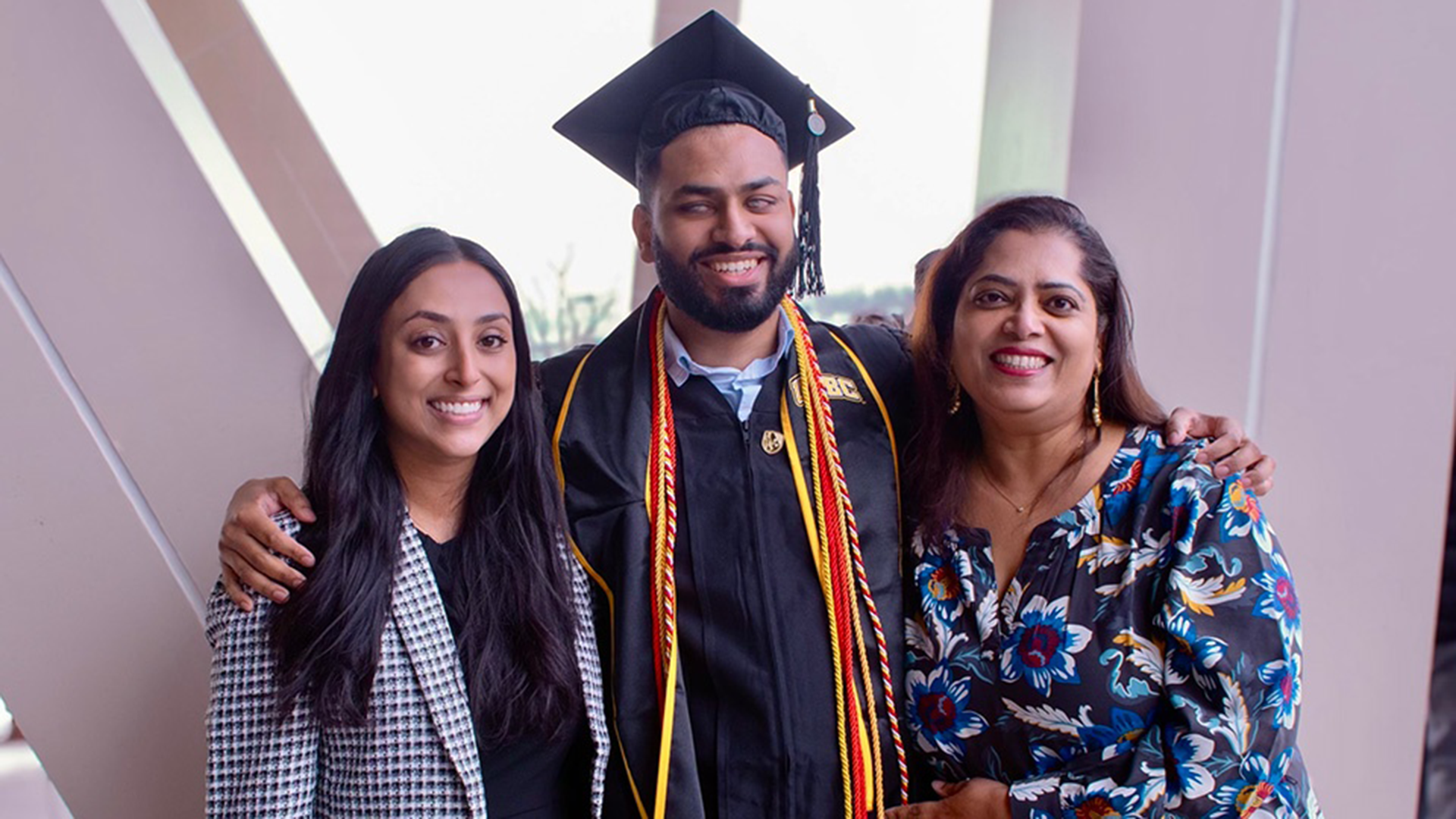 Alena Abraham, PharmD ’24, was inspired by her brother, Shawn Abraham, who lost his vision when he was 6 years old, to launch a podcast to help ensure that the stories of blind and visually impaired people are heard. Also shown is their mother, Sherly Abraham.