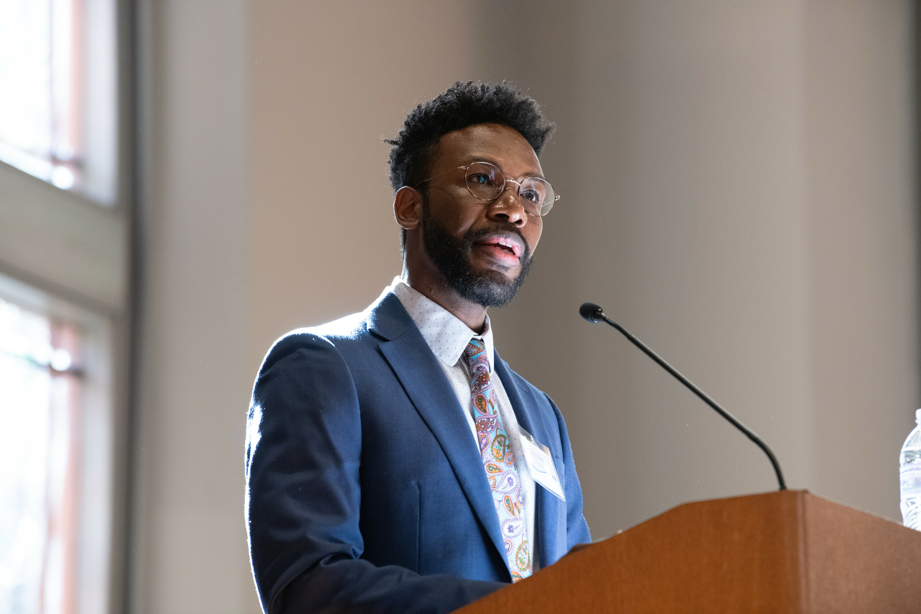 Law student speaking at a microphone stand