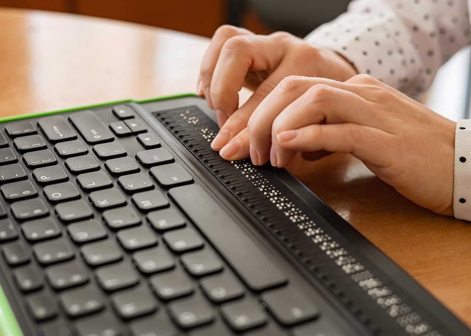 person using a braille keyboard