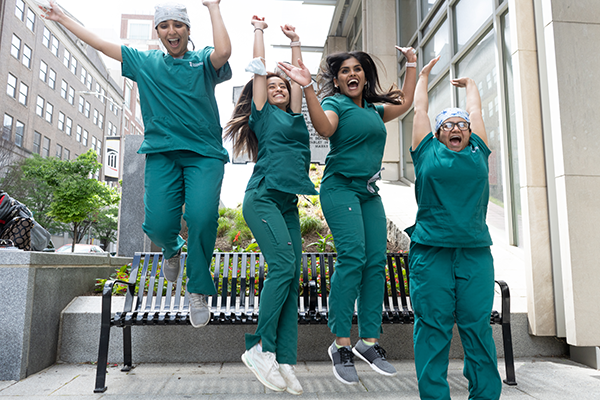 Students jumping off a bench