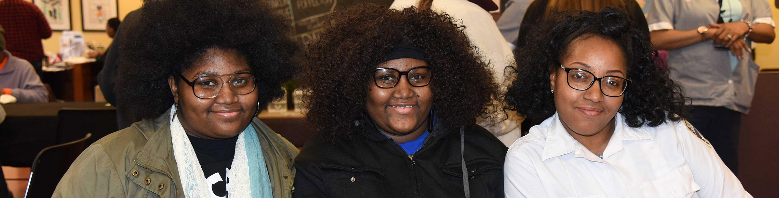 three professional women pose for the camera during lunch