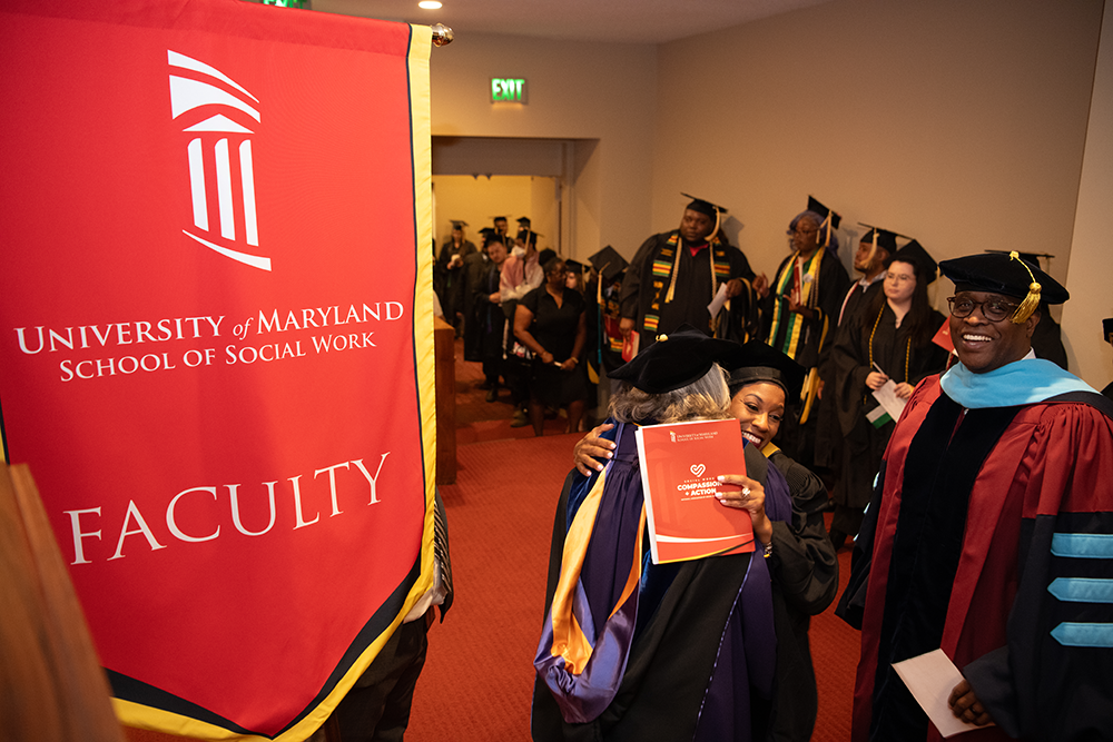 School of Social Work Banner with a person hugging another person