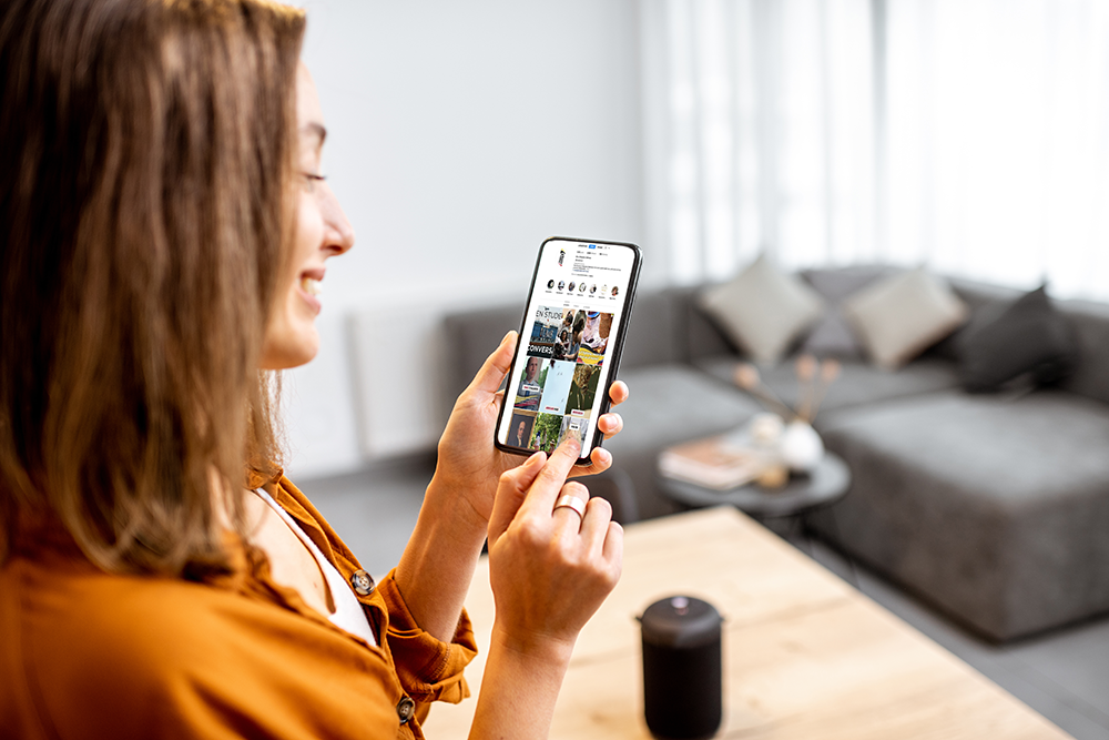 woman checks social media on a mobile device