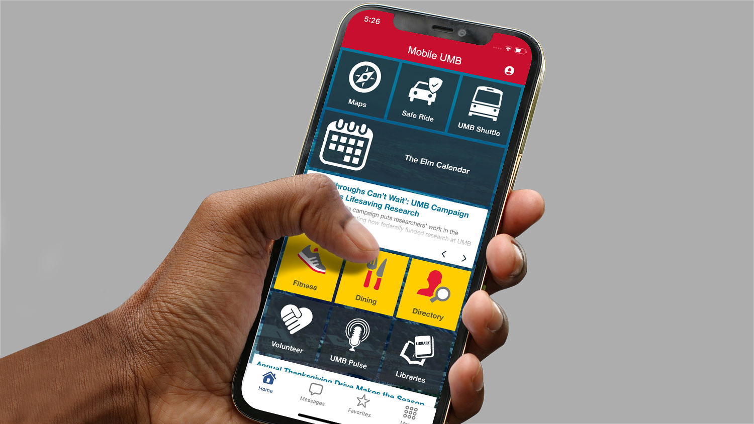 a hand holds a phone open to the mobile UMB app