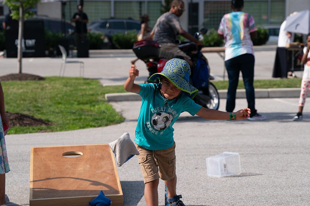 A child plays cornhole at the Juneteenth Jubilee