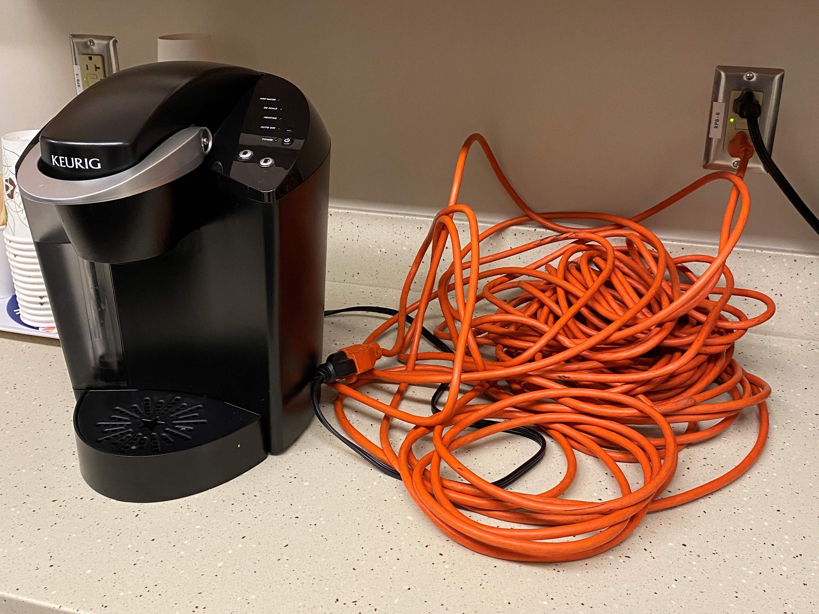 extension cord pulled into a coffee maker