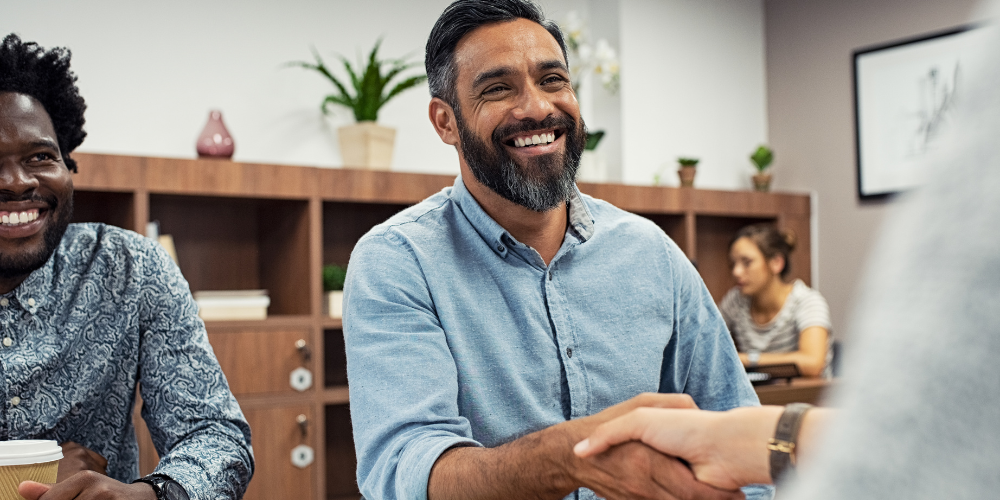 A man shakes another person's hand
