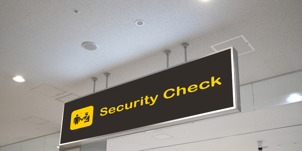 An airport sign reading Security Check