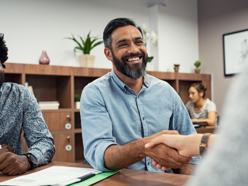 A man shakes hands with someone.