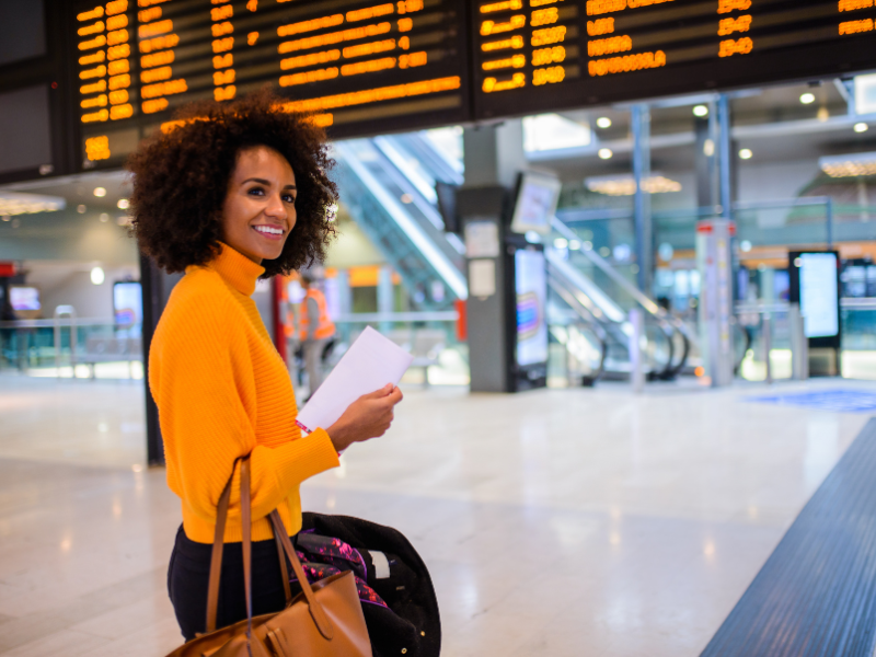 A woman carries a bag in a train station