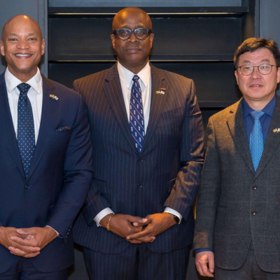 Gov. Wes Moore and Dr. Roger Ward meet with an official in Japan