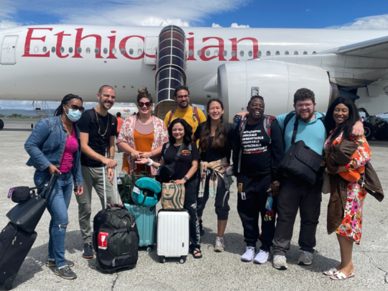 A group from UMB stands beside an Ethiopian Airlines airplane