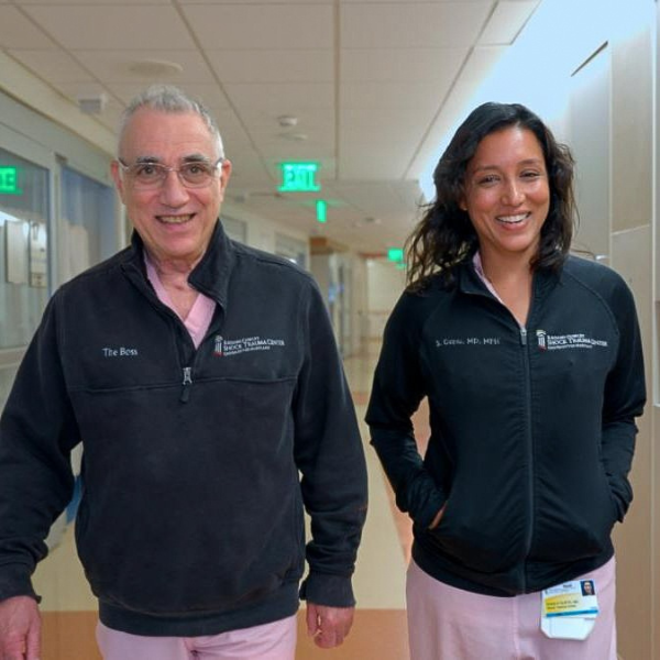 Dr. Thomas Scalea and Dr. Shailvi Gupta walk in the hallway of the UMMC Shock Trauma Center