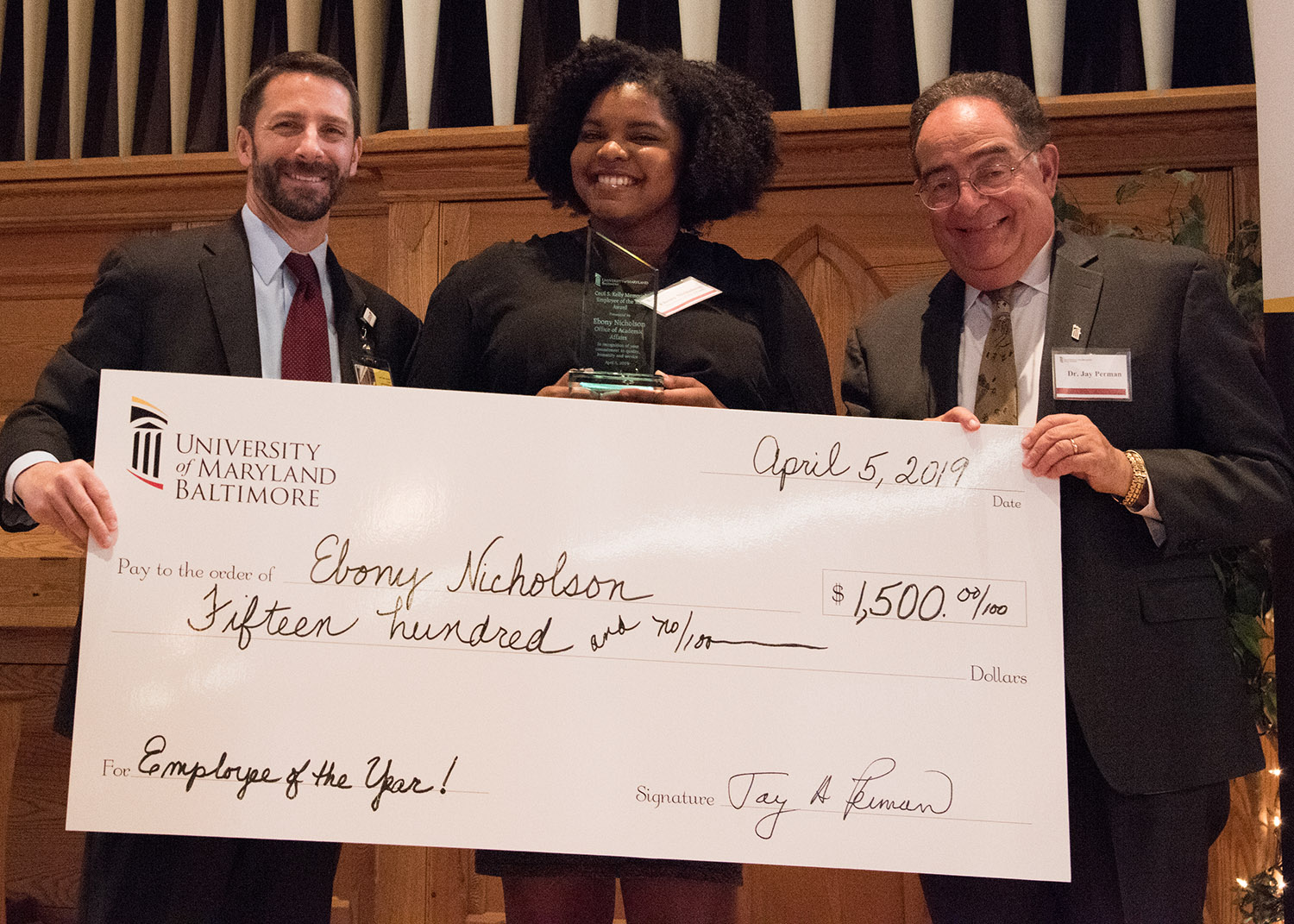 2019 UMB Employee of the Year Ebony Nicholson poses with her novelty check.