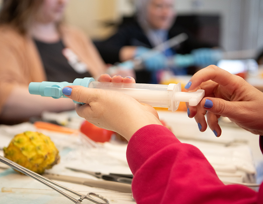 Students train with a medical device