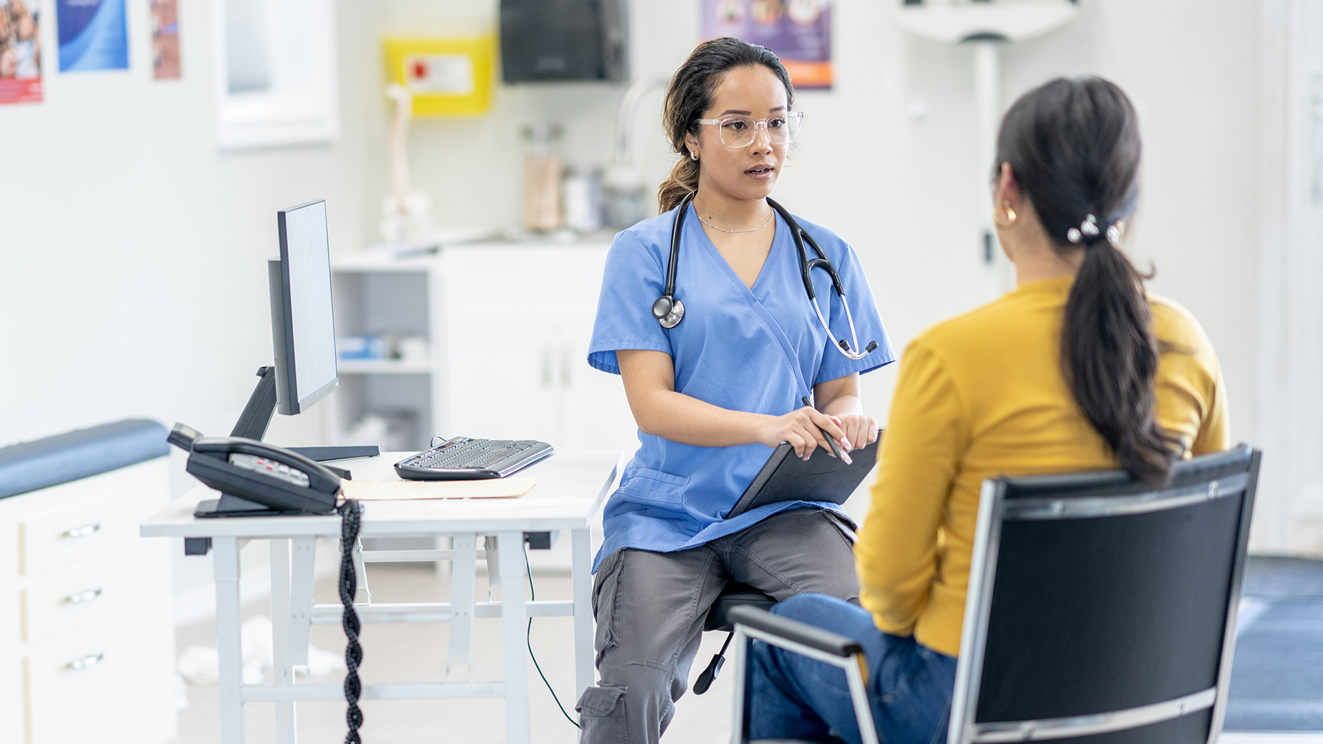 A doctor consults with a female patient