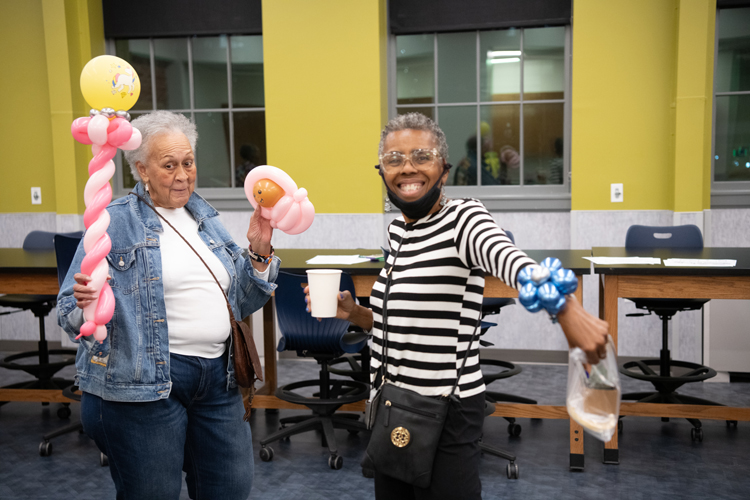 Community members celebrate with whimsical balloon creations during the Community Engagement Center's 10-year anniversary party.