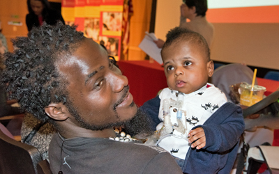 Dads holds kid on IPE Day