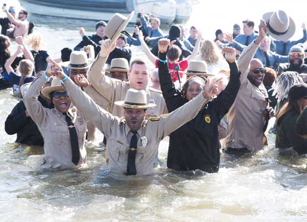 The University of Maryland, Baltimore Police Force Polar Bear Plunge team, UMB Cool, led by Sgt. Matthew Johnson (center), braves the icy Chesapeake Bay to raise money for Special Olympics Maryland. 