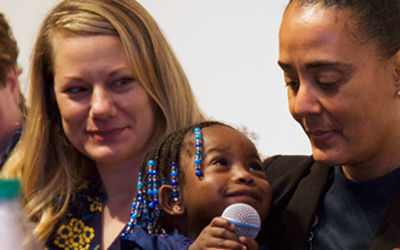 On IPE Day 2019, UMB Assistant Vice President Elsie Stines, DNP, MS, CRNP, holds 19-month-old Claudine, who is a patient in the President's Clinic.