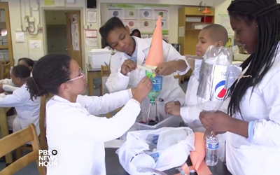 A group of University of Maryland, Baltimore CURE Scholars works on a science project at Franklin Square Elementary/Middle School as shown in a video by PBS NewsHour.