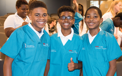 CURE Scholars Nicholas Knight, Courtney Jacobs, and Tyree Smith pose in their new scrubs on Aug. 5, 2016, at the University of Maryland School of Dentistry.