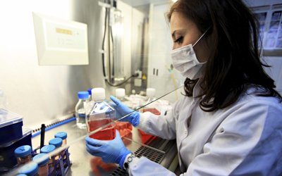 lab worker examines vials