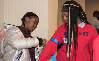 Students from James McHenry Elementary Middle School practice applying a tourniquet during their Stop The Bleed training session.