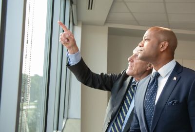 UMB President Bruce Jarrell shows Maryland Gov. Wes Moore the progress on construction of the 4MLK building in October 2023. The building opened in January 2025 and offers space for researchers, innovators, and entrepreneurs working in the sciences and technology industry.