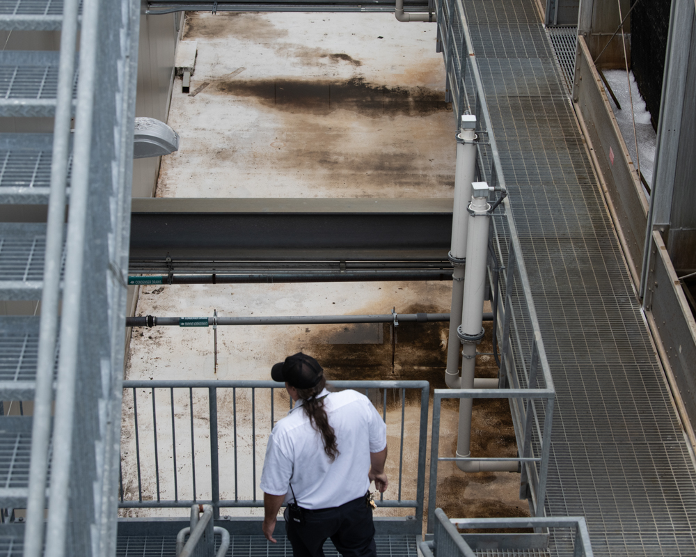 Joe Pfeiffer checks the cooling towers on top of the Pharmacy North Building. 