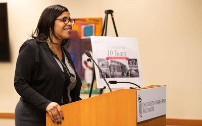Kay Lewis, UMB's director of Event Services, welcomes everyone to the SMC Campus Center's ten-year anniversary ceremony.