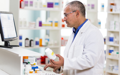 Pharmacist examines pill bottle