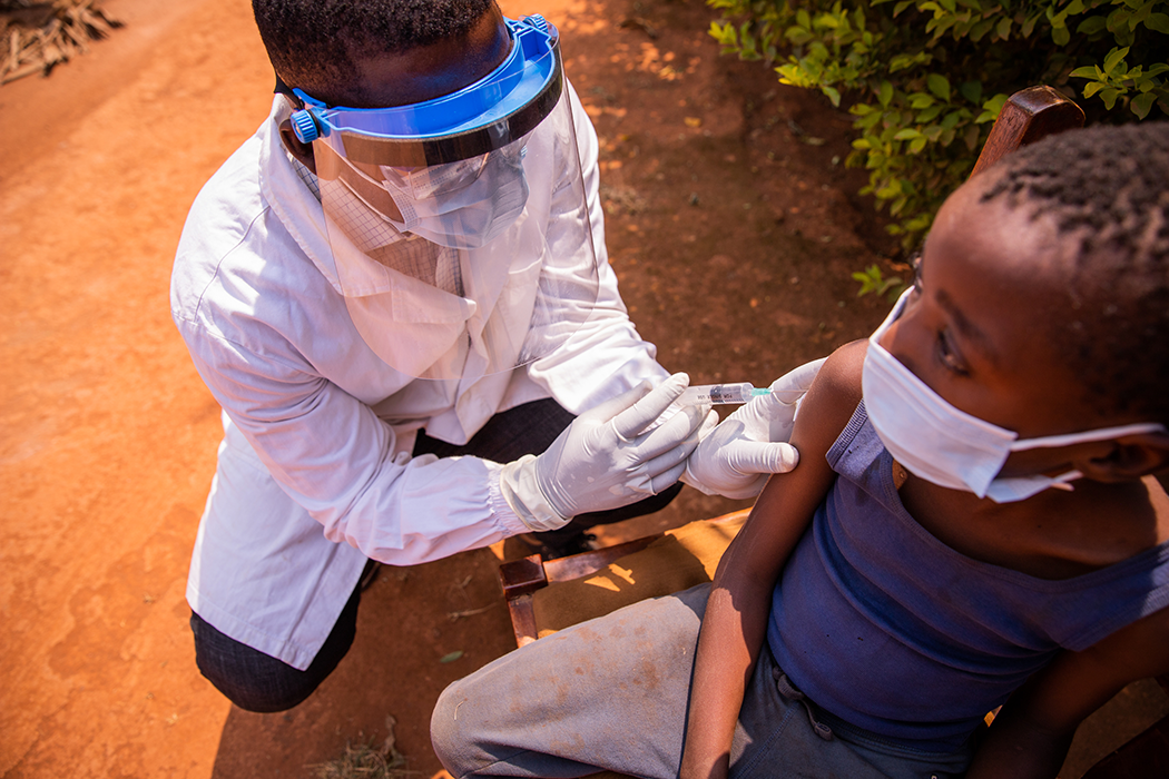 A kid getting a malaria shot