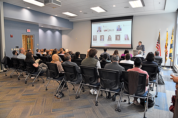 A presentation with the screen showing the leadership team on it.